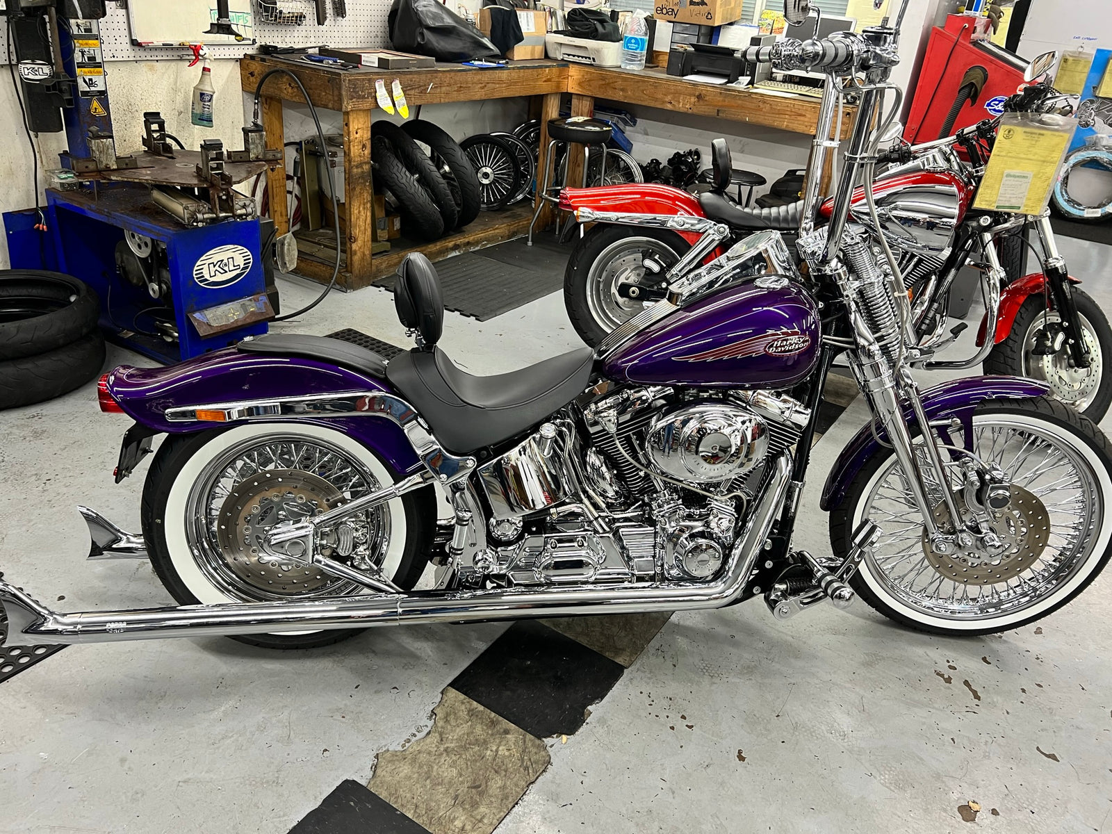 Purple custom softail on the lift at Iron Mike's
