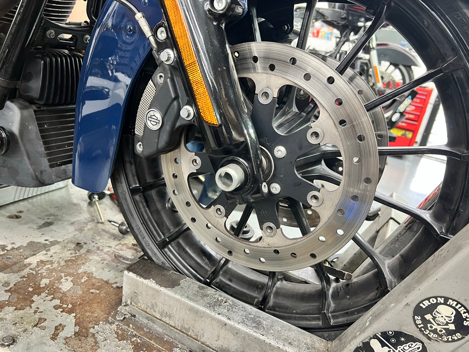 Front brake and wheel detail with Iron Mike's skull badge